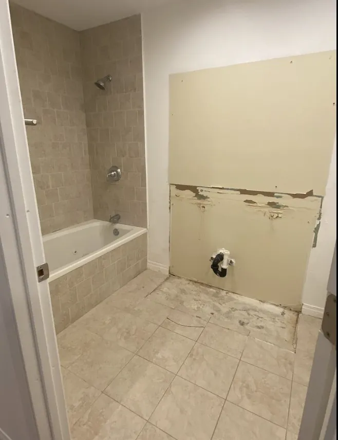 Bathroom demolition with vanity and drywall removed, ready for remodel