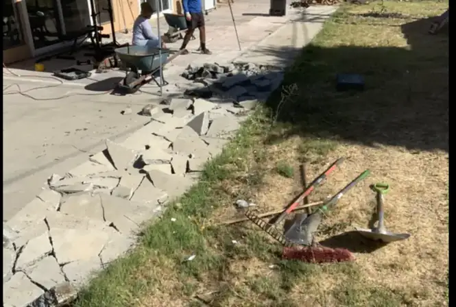 Concrete patio demolition and removal in a residential backyard